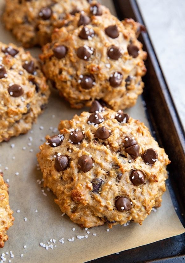 Sheet pan with peanut butter oatmeal cookies on top, fresh out of the oven.