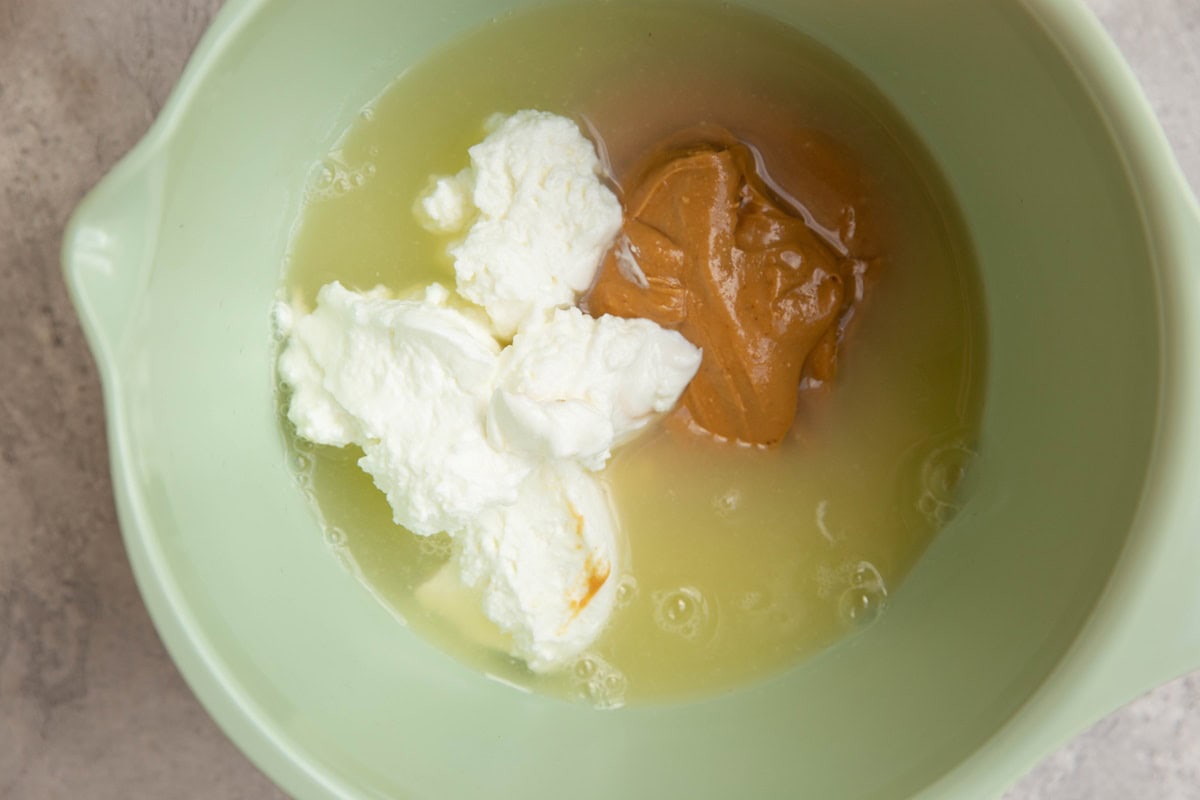 Wet ingredients for protein cookies in a mixing bowl.