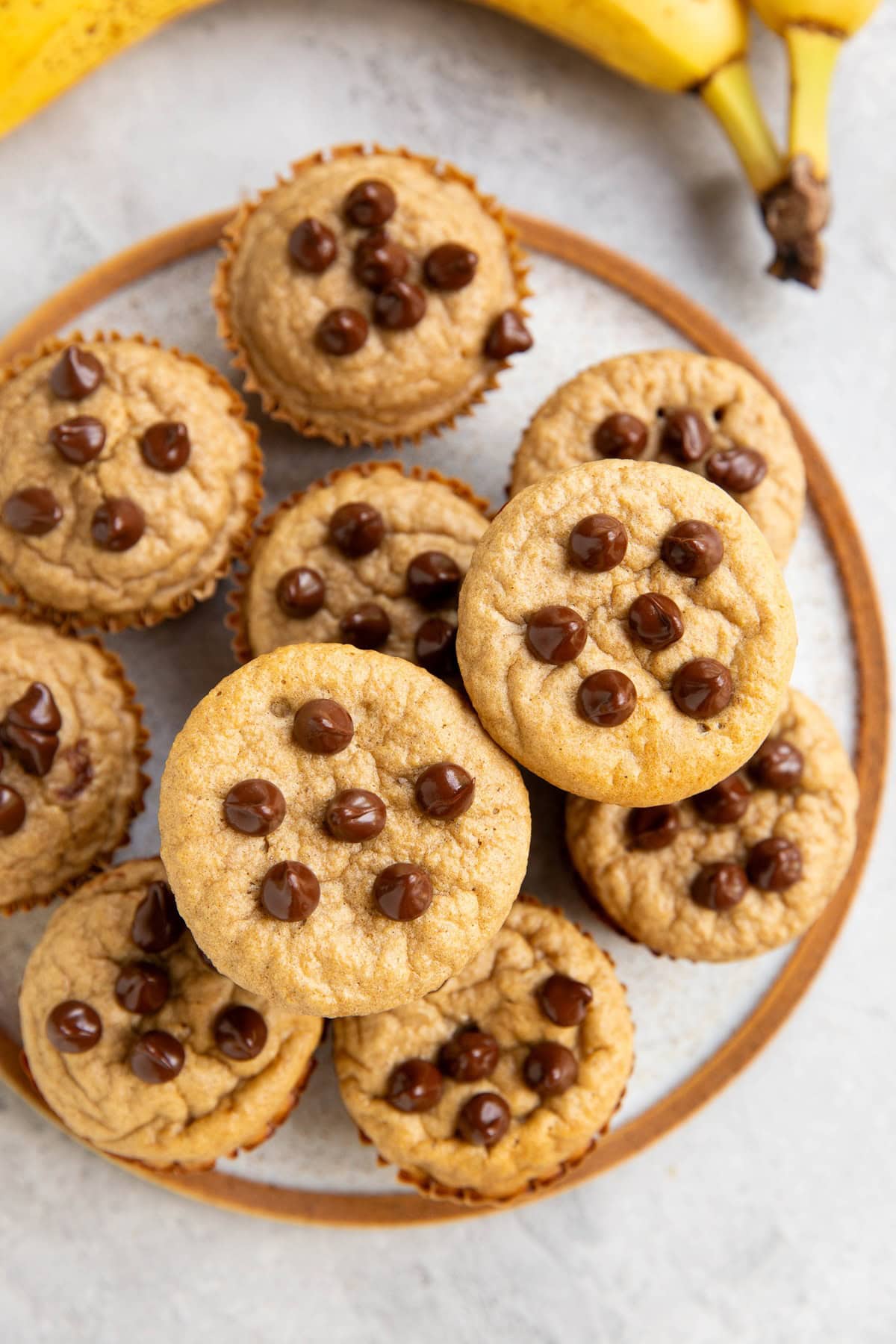 Plate full of banana muffins with chocolate chips.