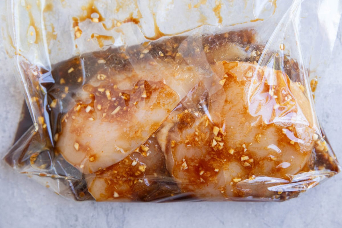 Marinated chicken in a large zip lock bag.