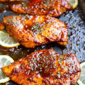 Sesame ginger garlic chicken fresh out of the oven with a delicious looking golden brown glaze.