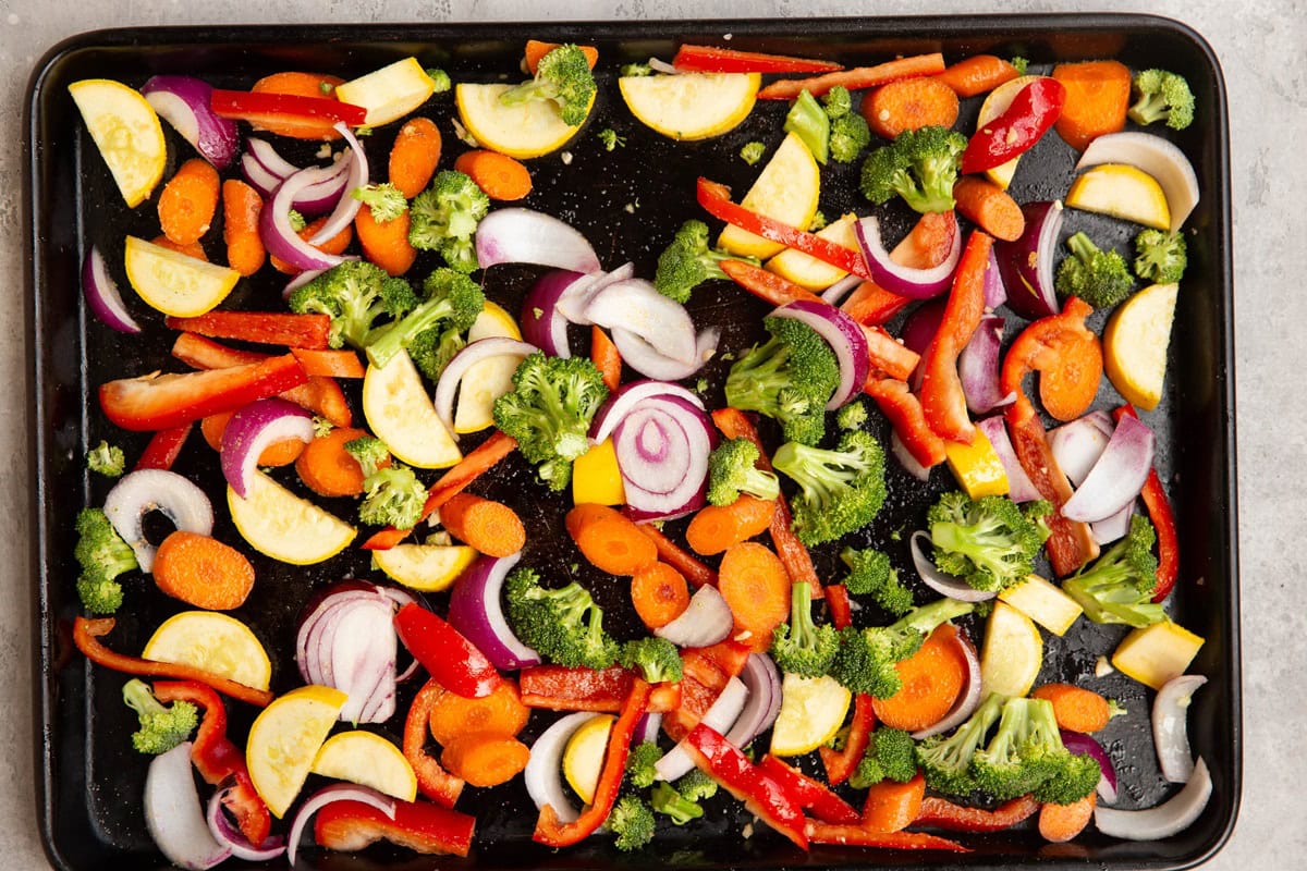 Sheet pan with vegetables spread over it