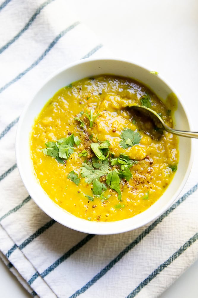 White bowl full of lentil curry.