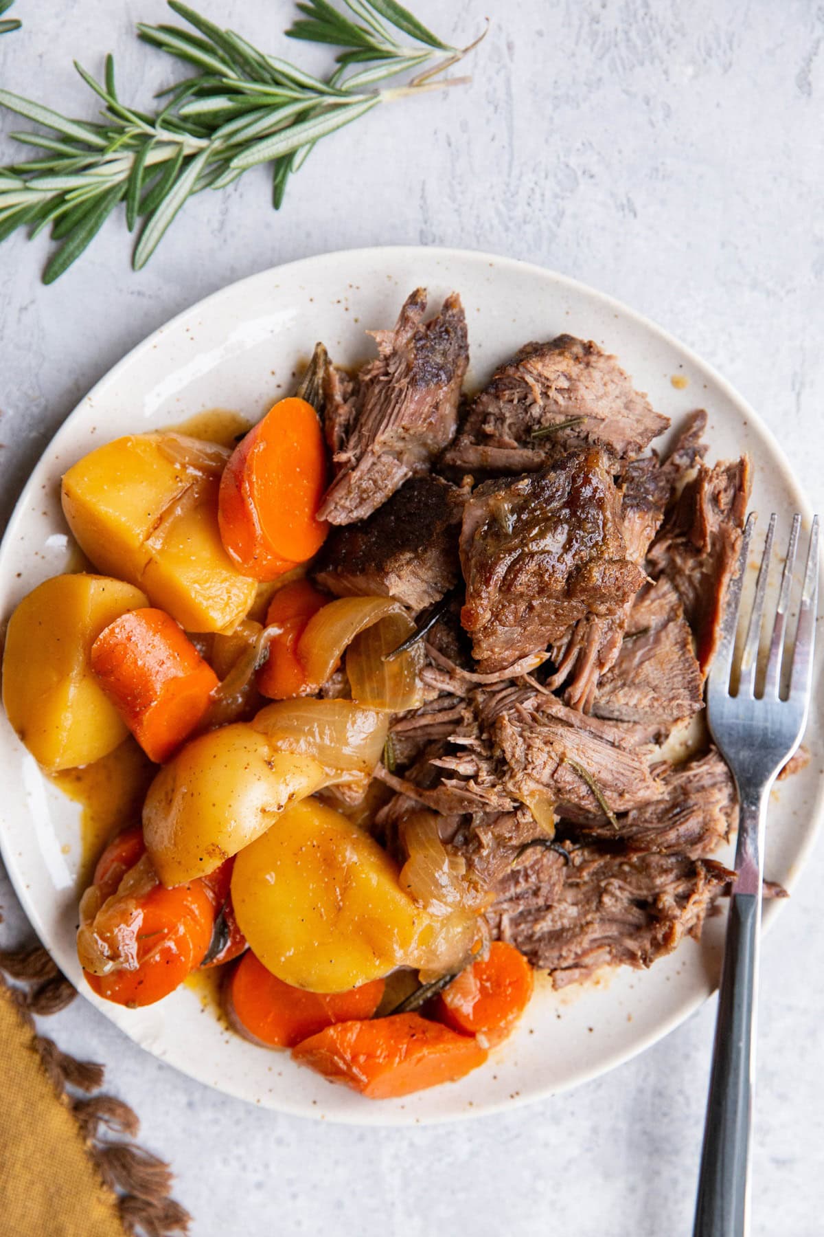 Plate of beef roast and potatoes and carrots, ready to eat.