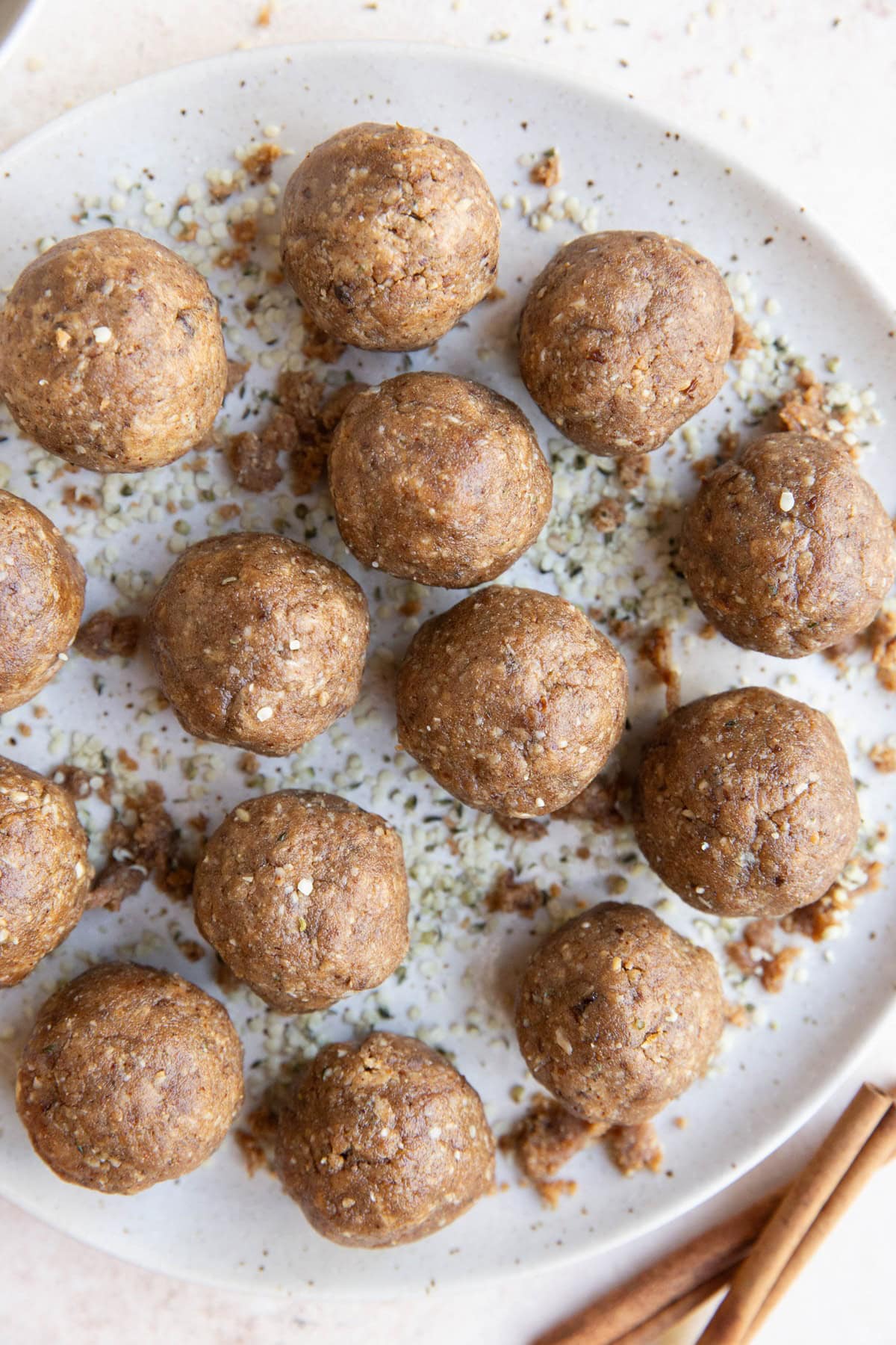 White plate of cinnamon raisin energy balls, ready to eat.