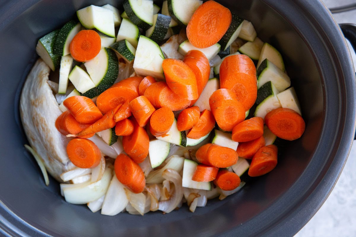 Vegetables and chicken in a crock pot.