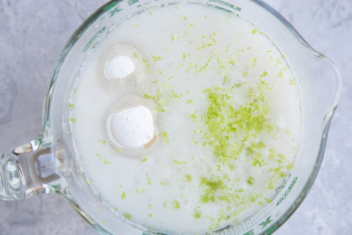 Ingredients for coconut lime sauce in a mixing bowl, ready to use.