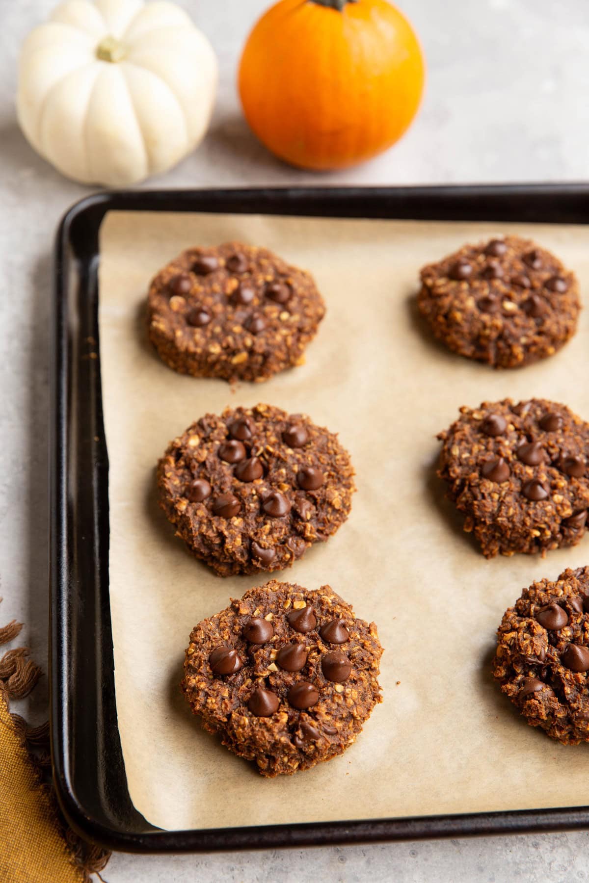 Chocolate pumpkin oatmeal cookies on a large baking sheet.