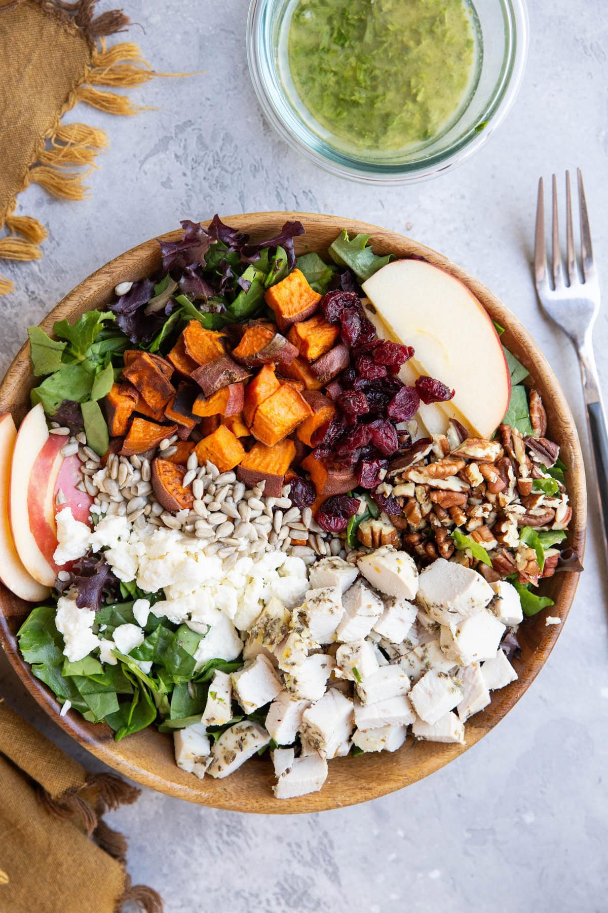 Wooden bowl of fall harvest salad with chicken and sweet potato