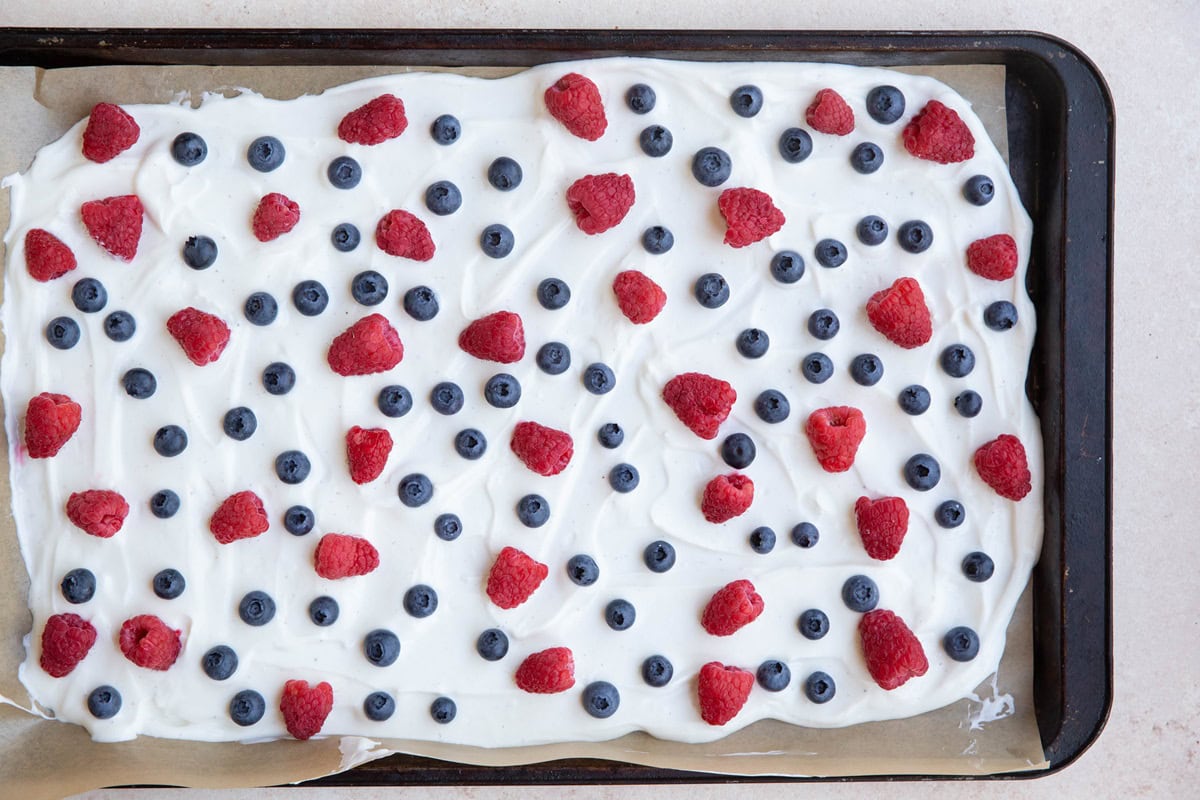 Berries sprinkled over a layer of yogurt