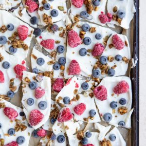 Baking sheet with yogurt bark broken into individual pieces.