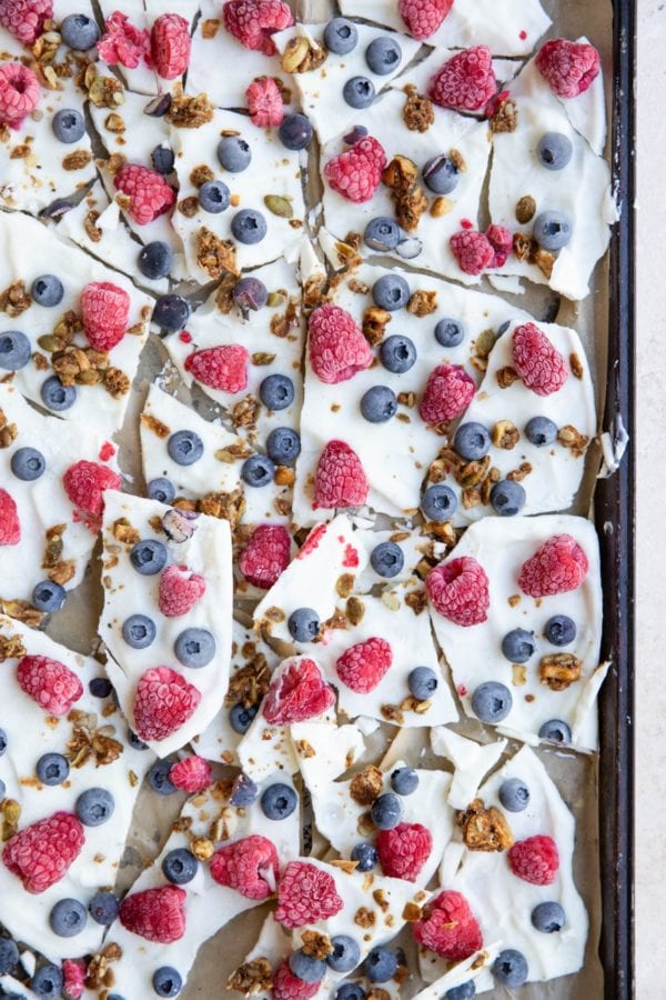 Baking sheet with yogurt bark broken into individual pieces.