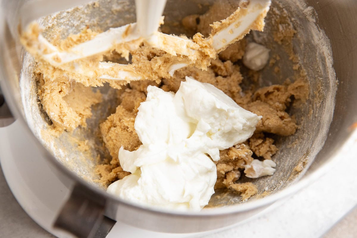 Greek yogurt on top of coffee cake batter, ready to be mixed in.