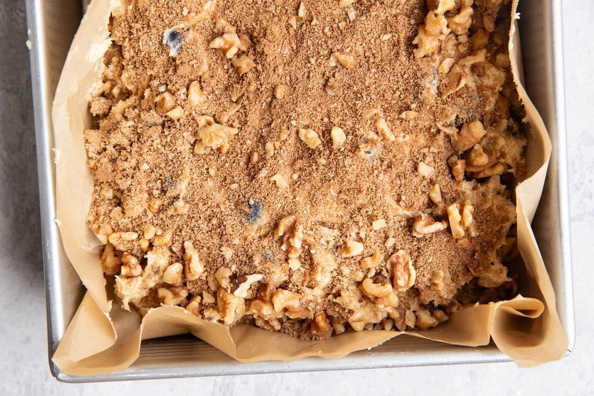 Coffee cake batter with streusel topping sprinkled on top.