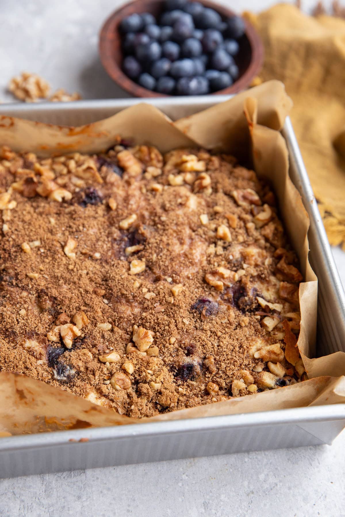 Yogurt coffee cake with blueberries in a baking pan.