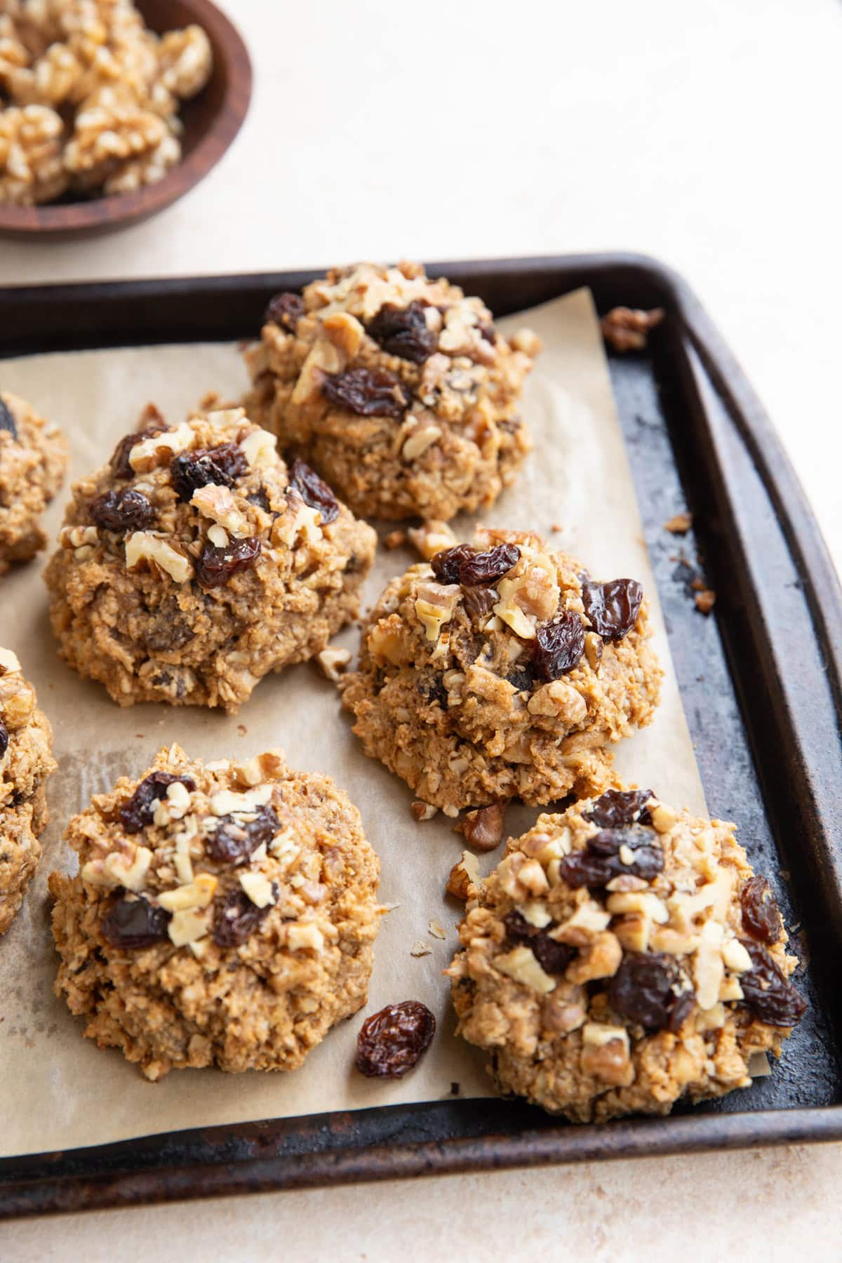 Baking sheet with peanut butter oatmeal raisin cookies fresh out of the oven.