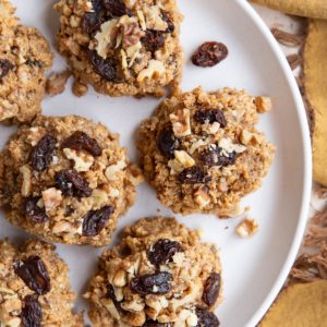 White plate full of peanut butter oatmeal raisin cookies.