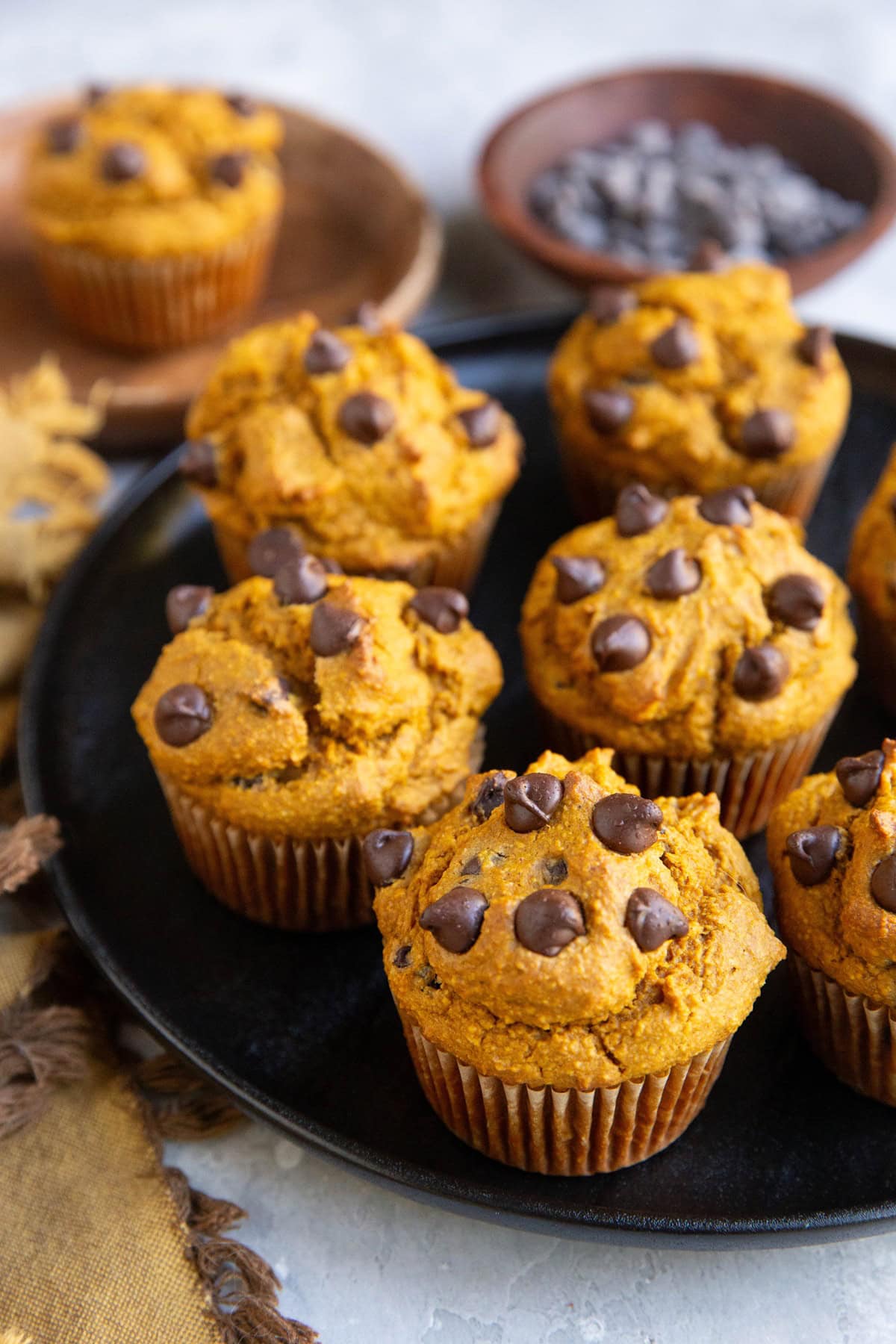 Black plate of pumpkin muffins.