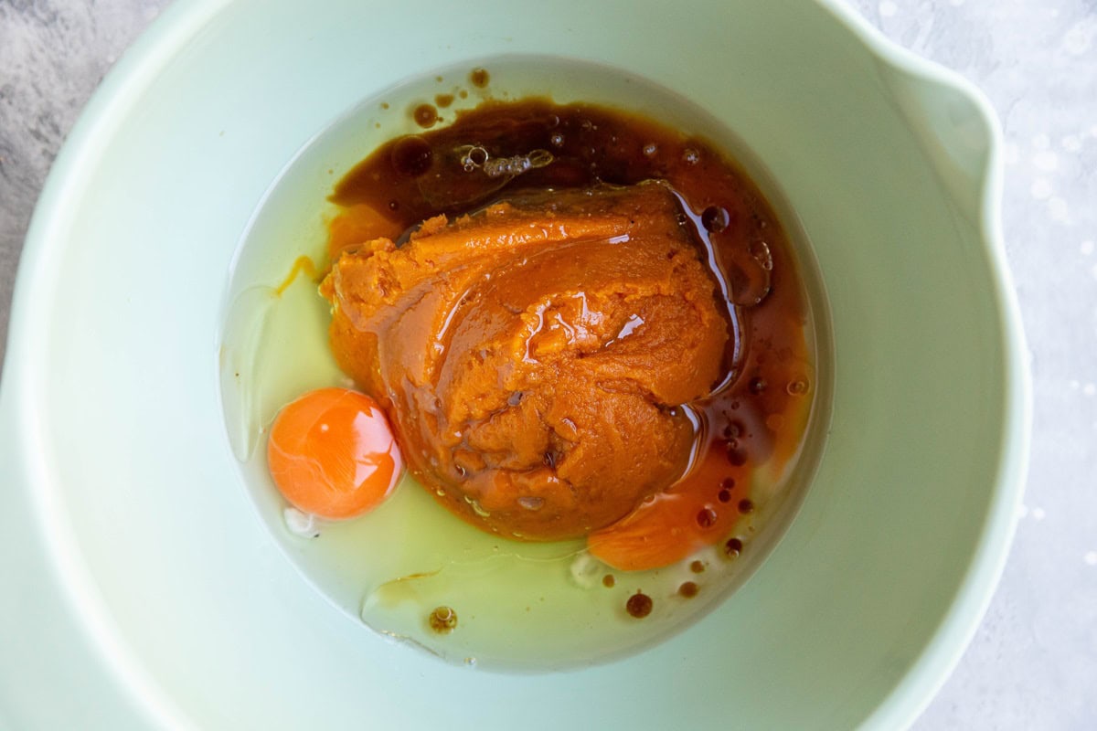 Mixing bowl with wet ingredients for pumpkin muffins.