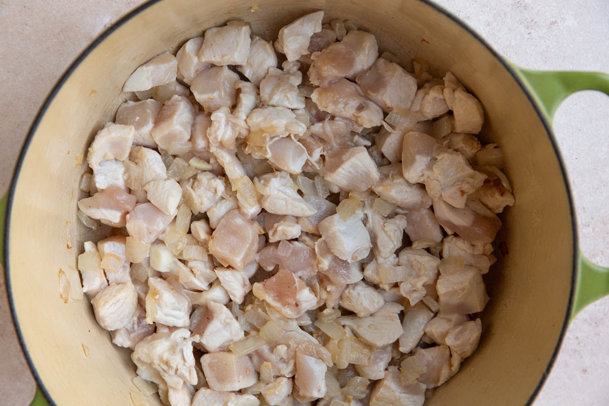 Big pot of chicken and onions cooking together.