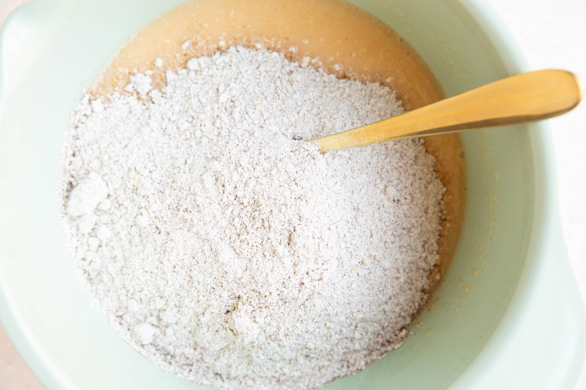 Dry ingredients on top of wet ingredients in a mixing bowl.