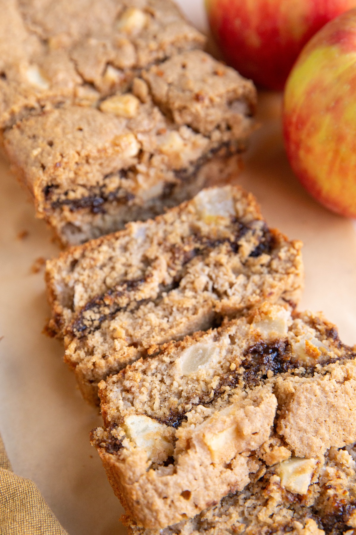 Loaf of apple cinnamon swirl bread cut into slices.