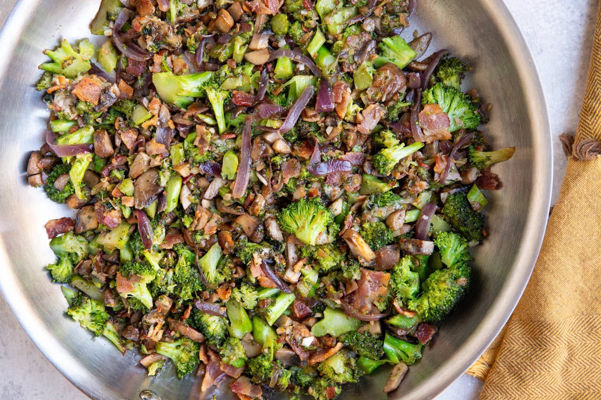 Stainless steel skillet full of cooked vegetables, ready to serve.