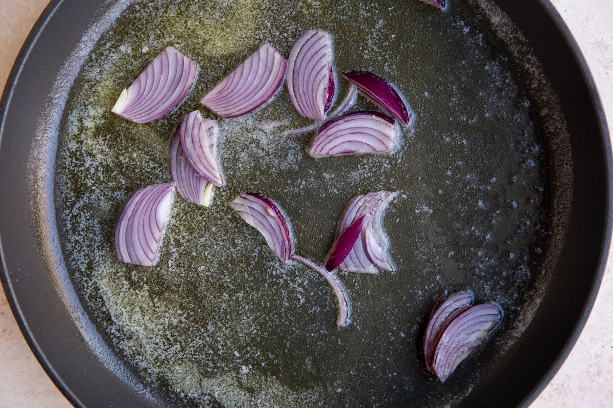 Sliced onions cooking in a skillet