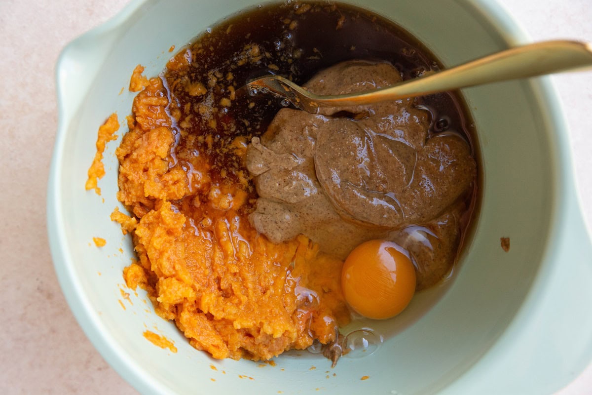 Mashed potato, egg, almond butter, and pure maple syrup in a mixing bowl to make protein brownies