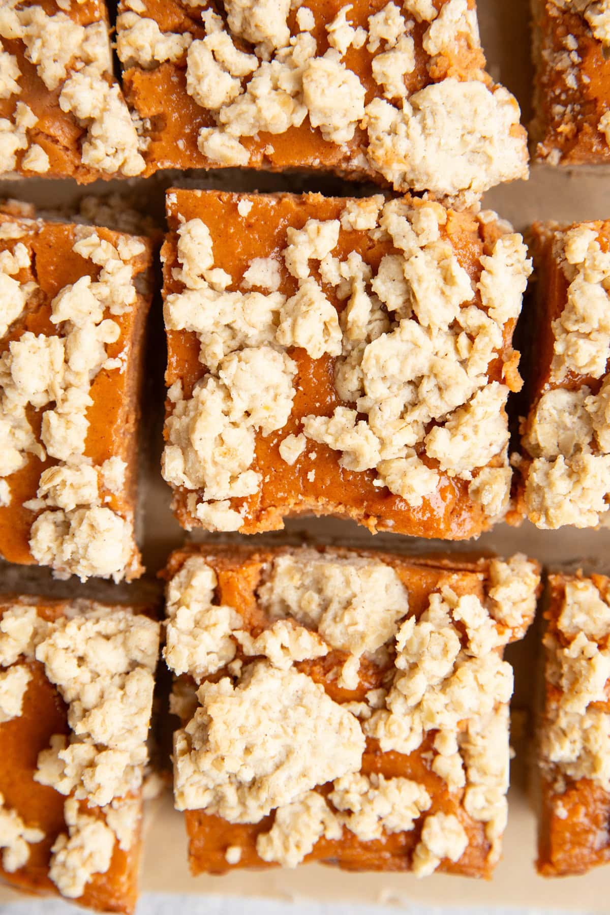 Sweet Potato crumb bars on a sheet of parchment, cut into slices.