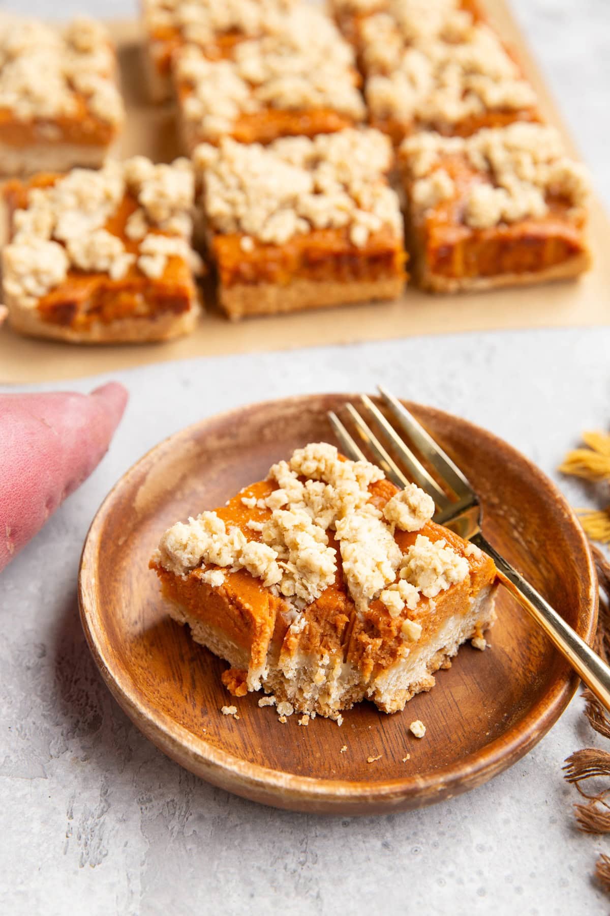 Wooden plate with crumb bar with bite taken out.