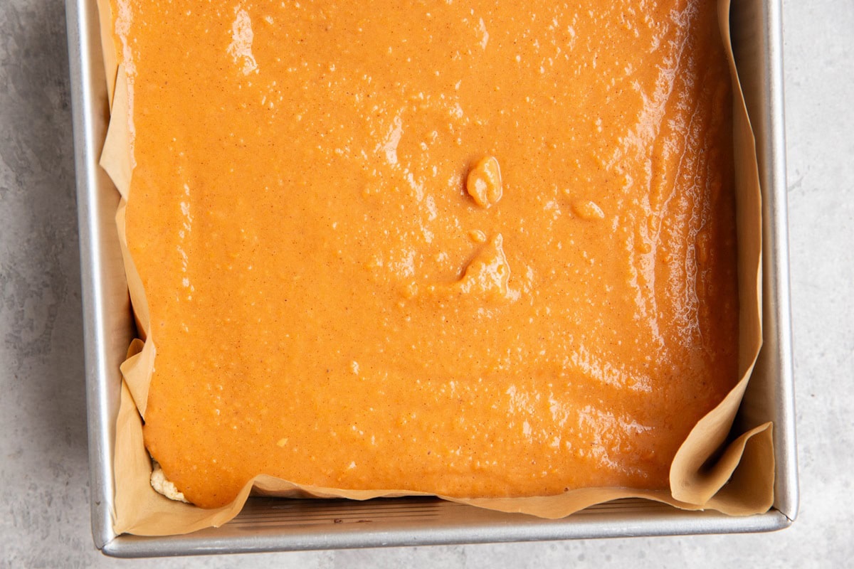 Sweet potato pie filling in a square pan, ready to go into the oven.