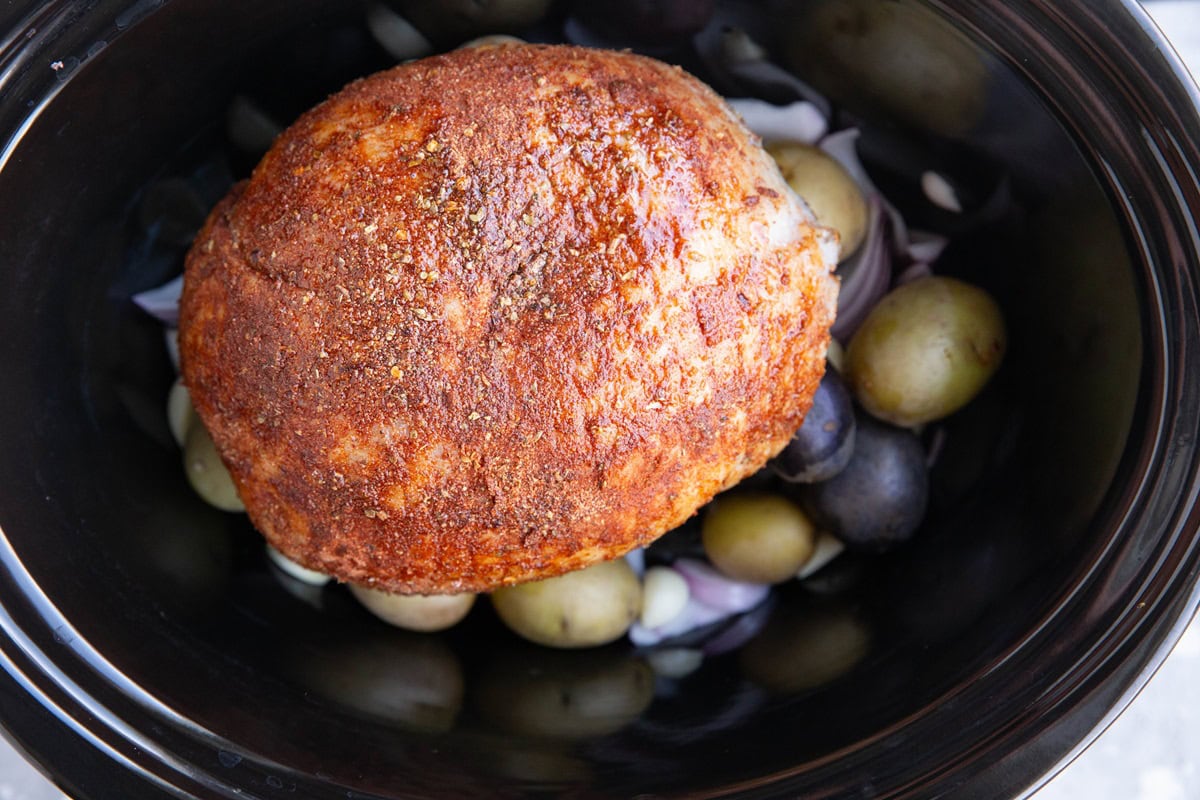 crock pot full of onions, potatoes, and turkey breast.