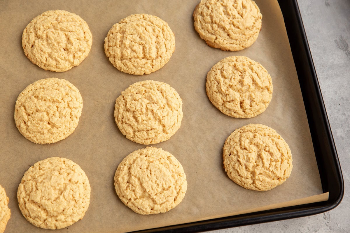 Baking sheet with finished peanut butter cookies fresh out of the oven.