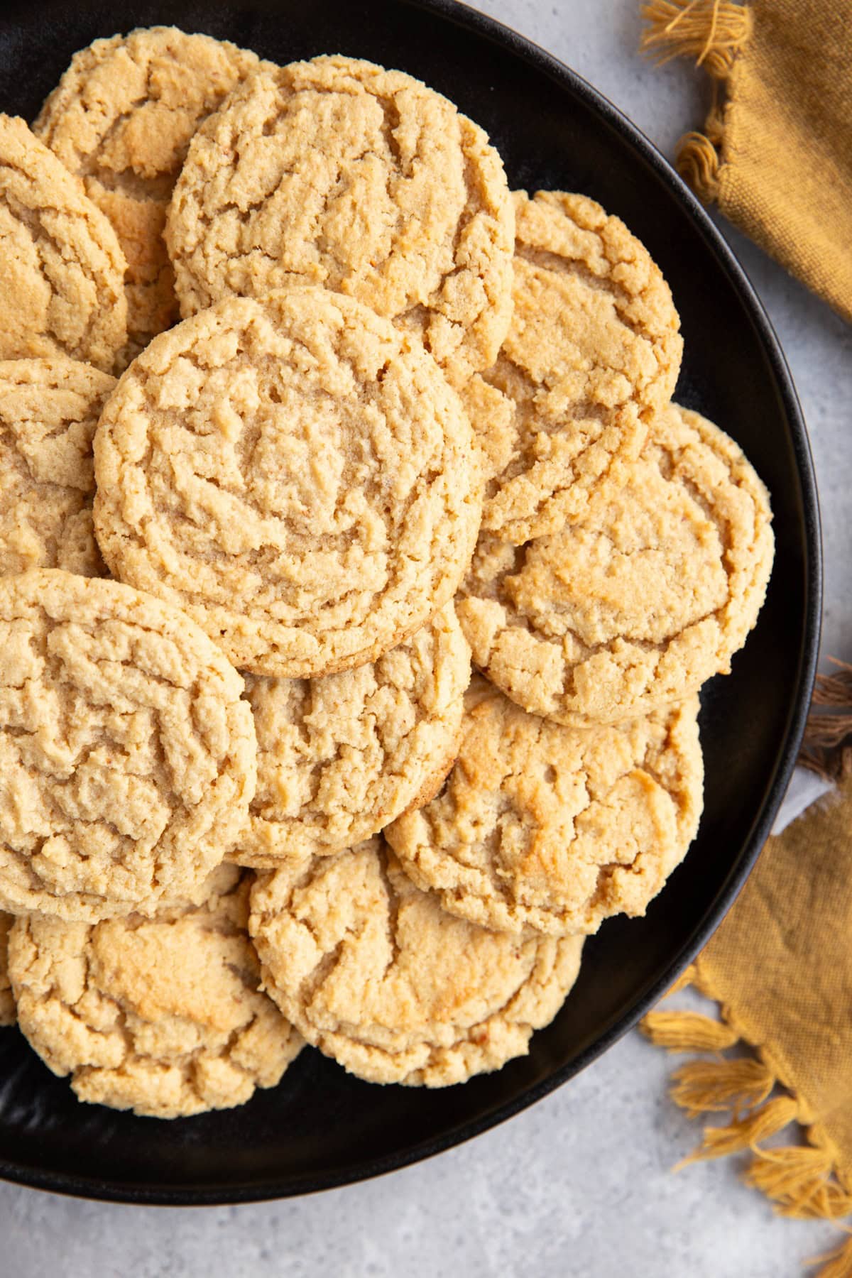 Large black plate with grain free cookies on top.