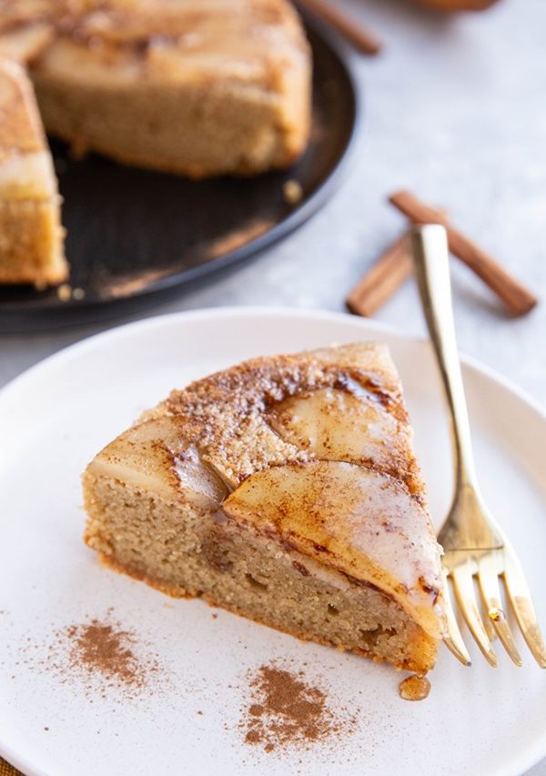 slice of almond flour pear cake on a plate, ready to serve.