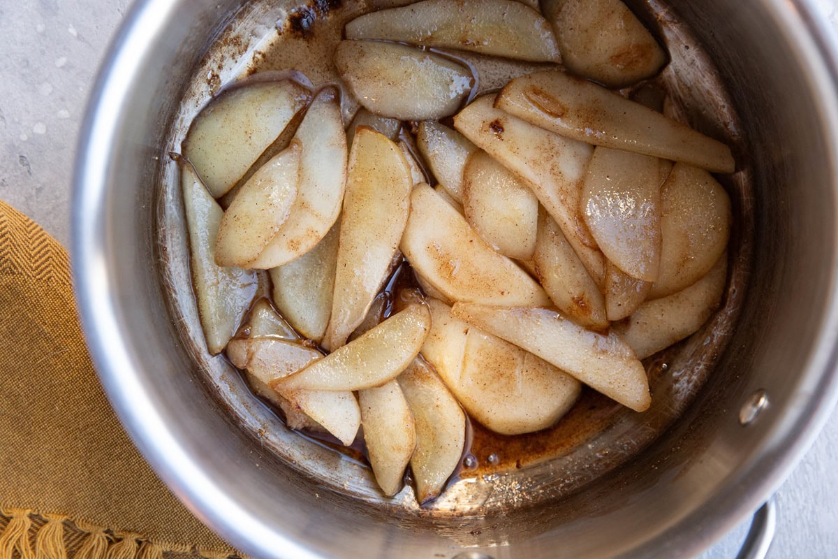 Pot of sliced pears with pure maple syrup and cinnamon