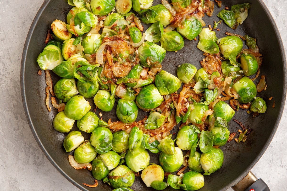 Skillet with brussel sprouts and caramelized onions.