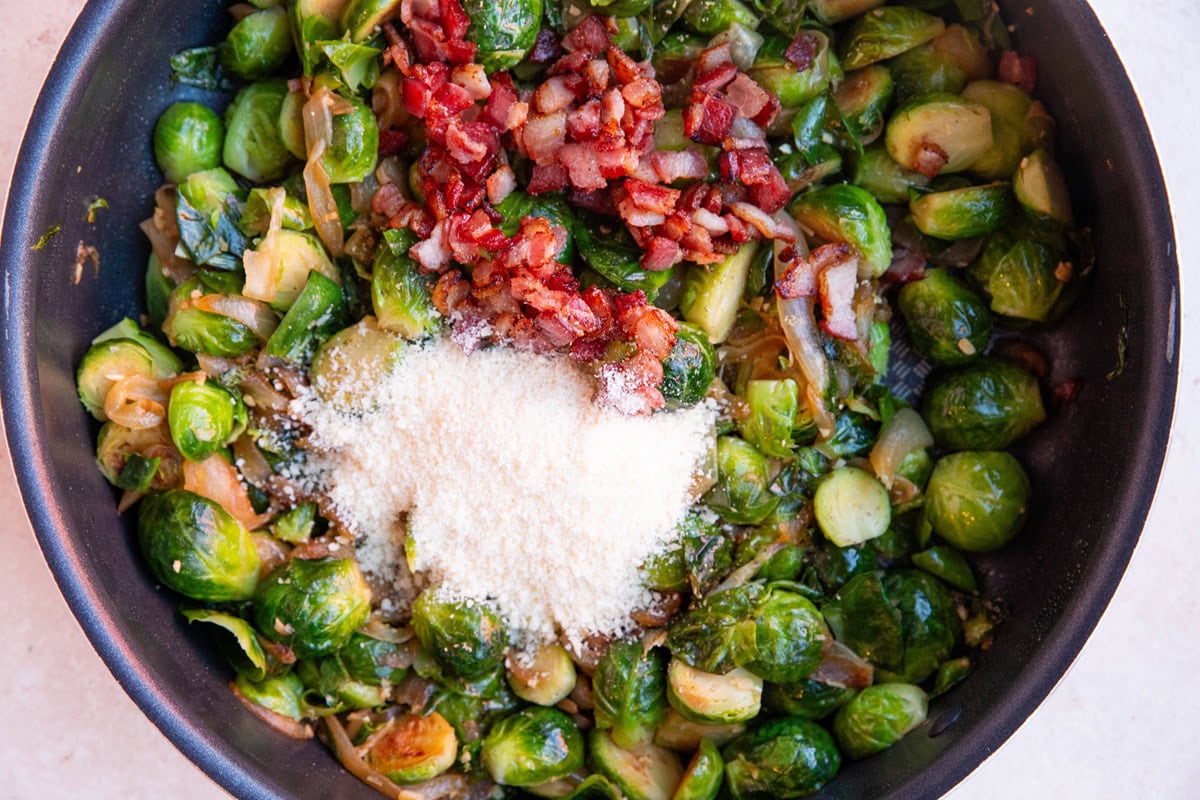 Skillet of brussel sprouts, caramelized onions, bacon, and parmesan cheese.