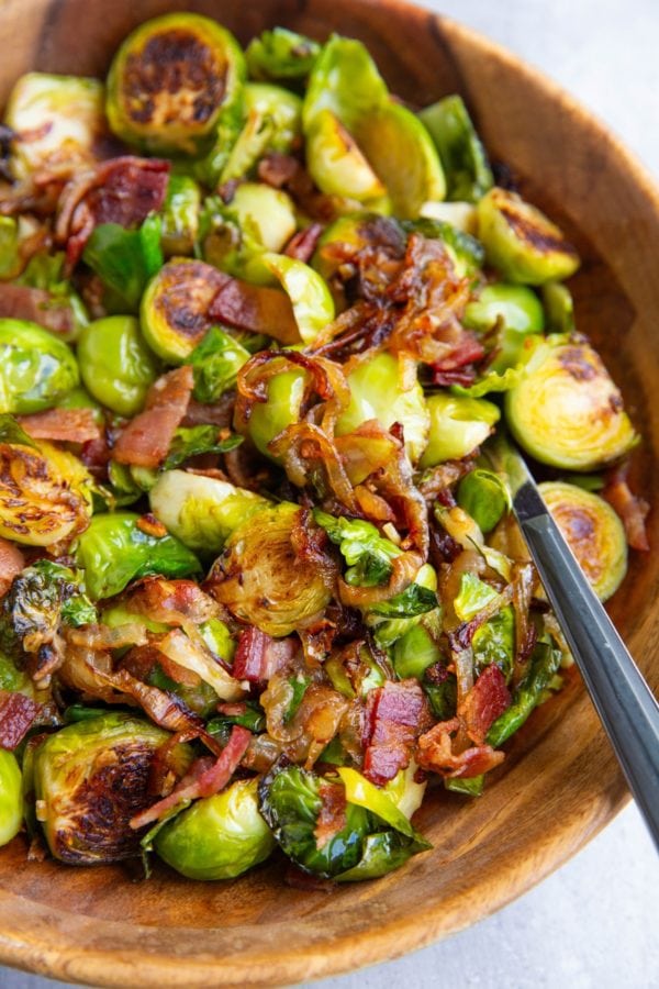 Wooden bowl full of brussel sprouts, ready to serve.