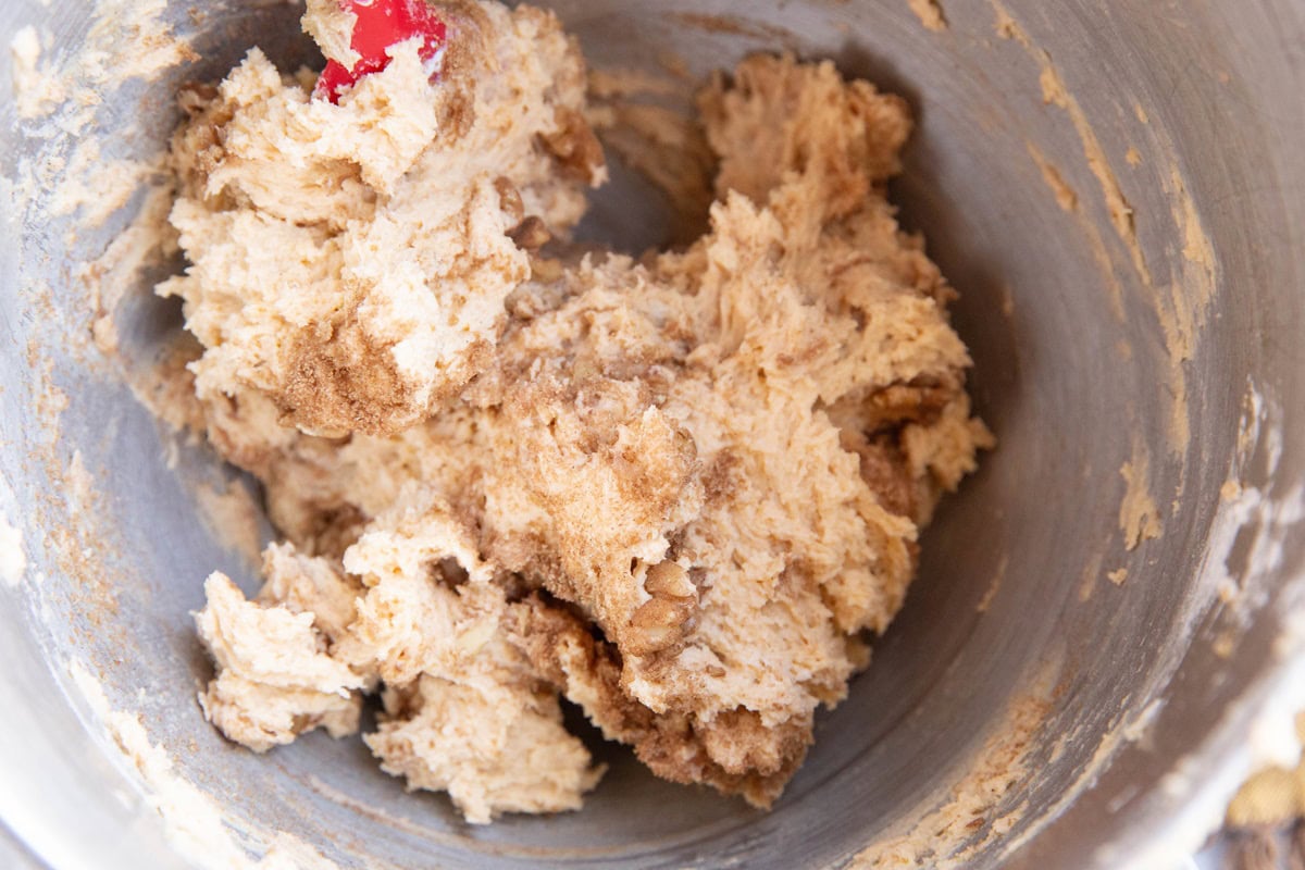 Coffee cake muffin batter with cinnamon swirl mixed in.