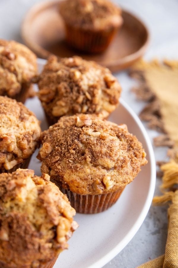 White plate with coffee cake muffins on top, ready to serve.