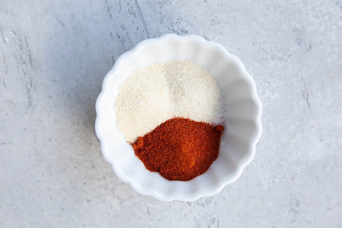 Garlic powder, onion powder, and paprika in a small bowl to be used on chicken.