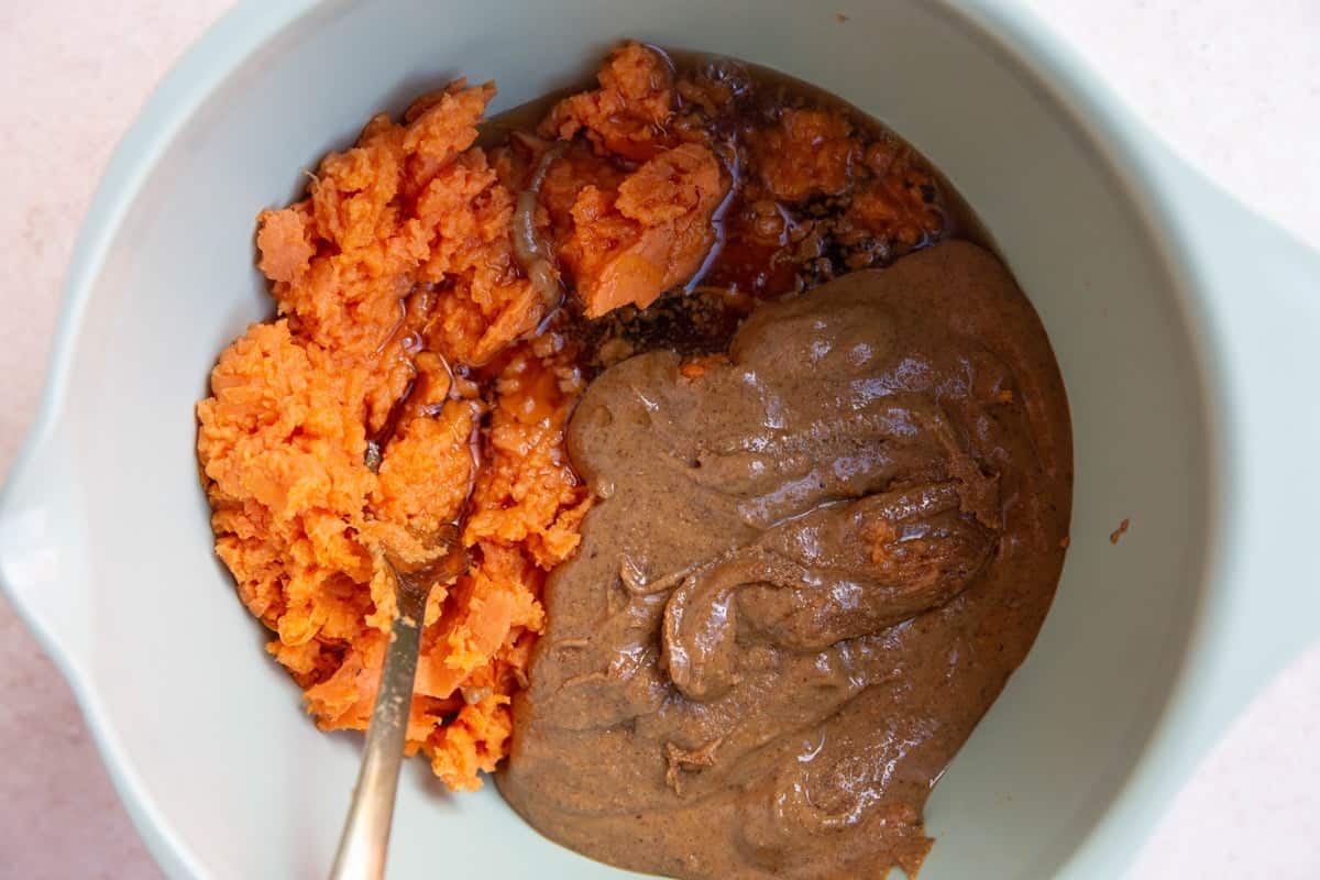 Mashed sweet potato, almond butter, and pure maple syrup in a mixing bowl.