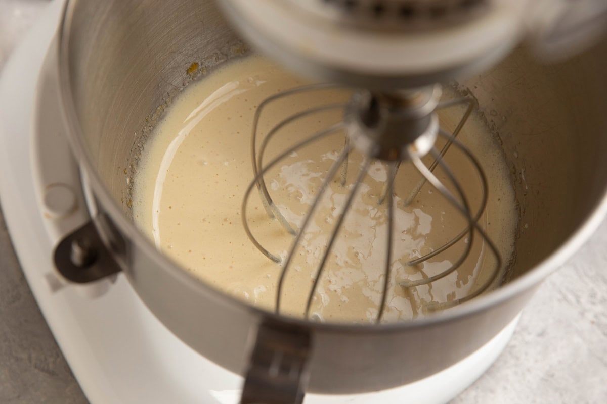 Stand mixer with eggs and sugar whipped together.