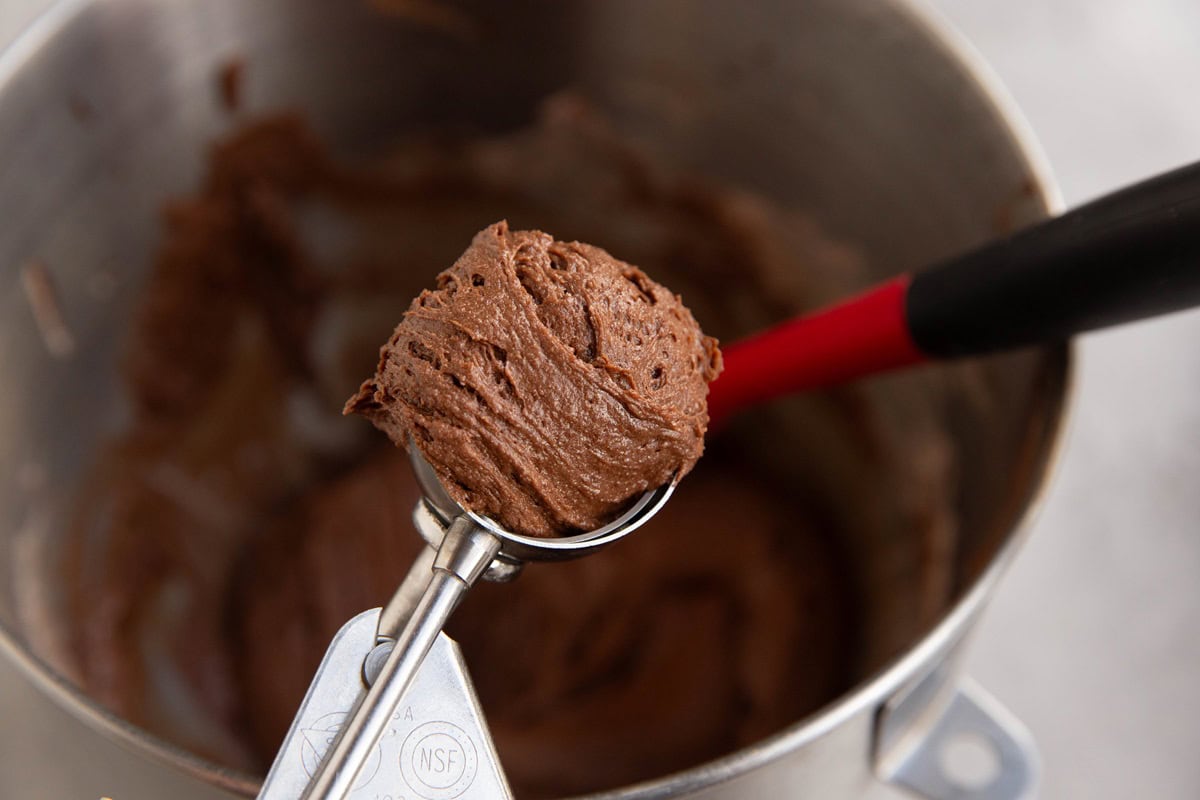 Small cookie scoop with brownie batter inside.