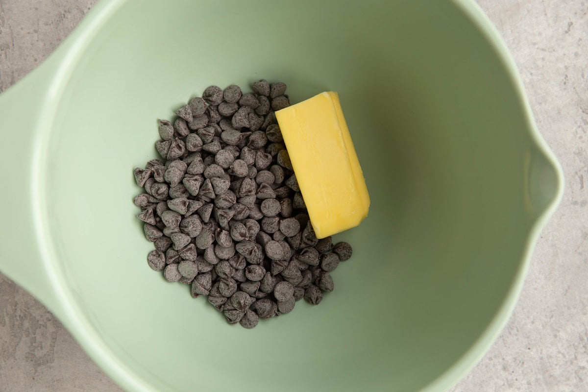 Chocolate chips and butter in a mixing bowl.