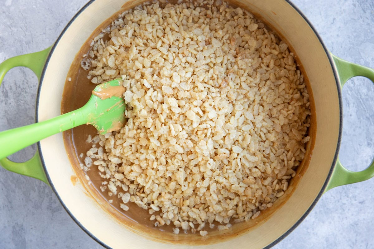 Pot full of peanut butter mixture and rice krispies cereal.