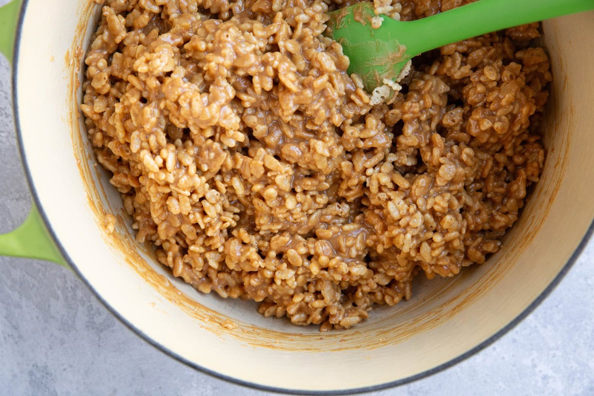 Peanut butter rice krispies mixture in a large pot, ready to be made into no bake bars.