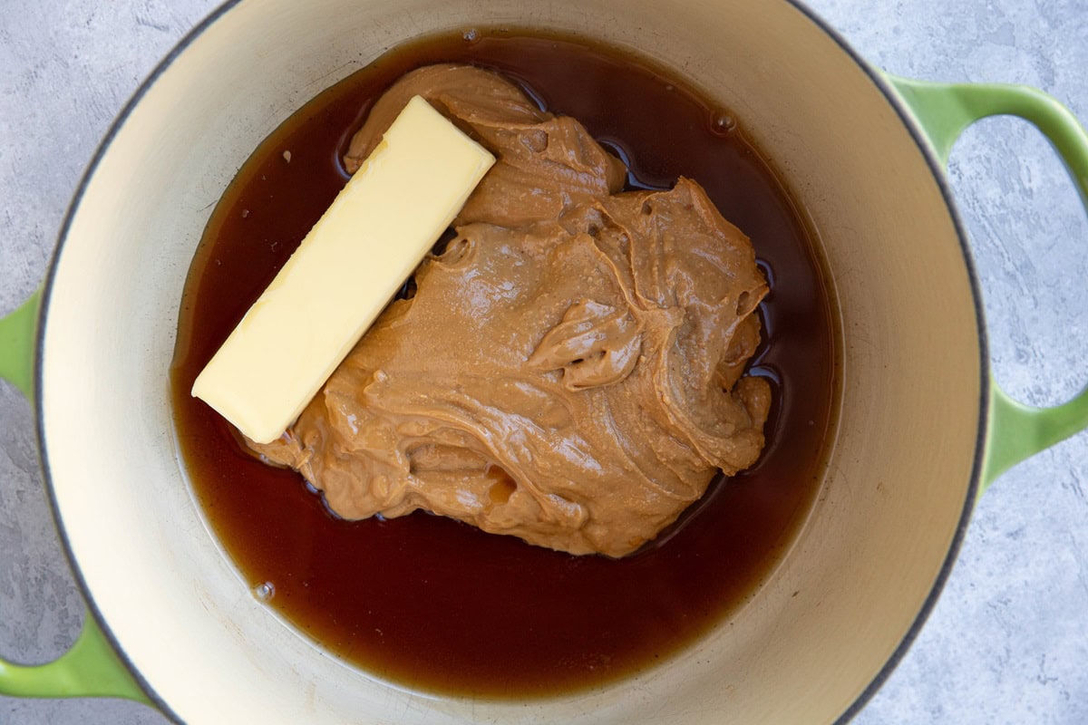 Large pot with peanut butter, pure maple syrup, and butter inside.